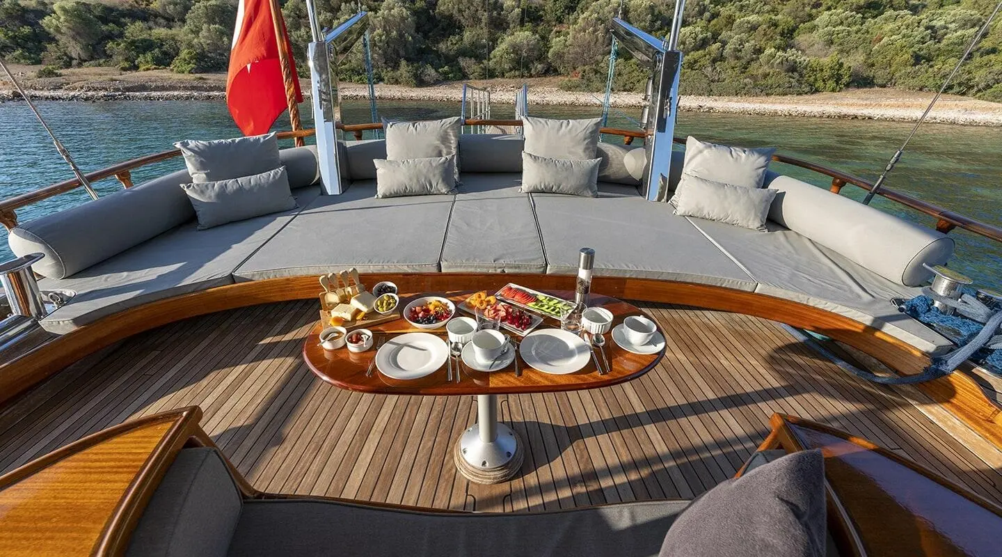 Bedia Sultan yacht aft deck with served plates on wooden table
