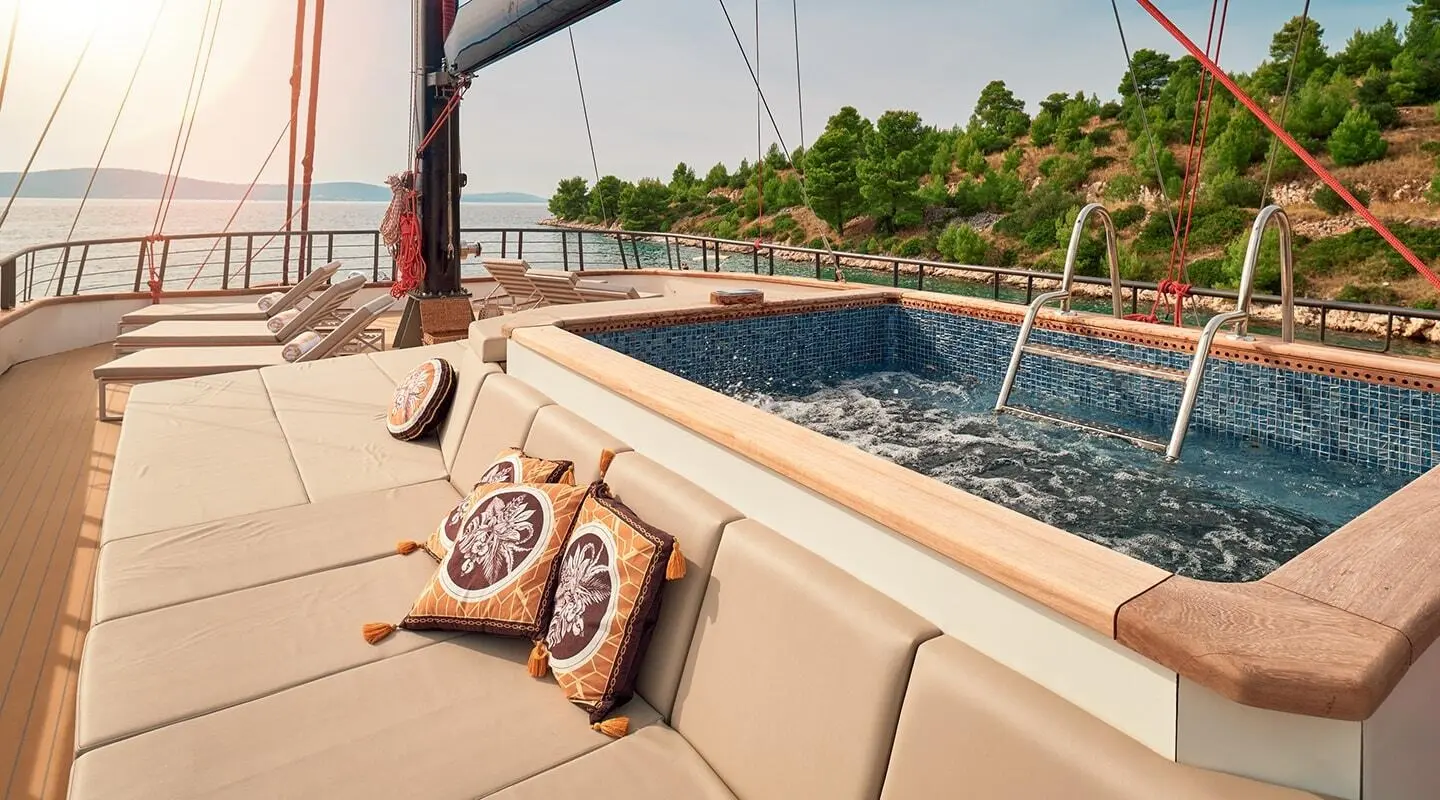 Anetta motoryacht on deck with a jacuzzi and scenic view ahead