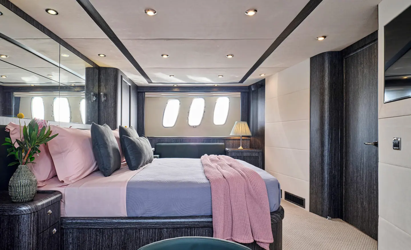 Interior of luxury yacht M Five bedroom with bed, windows, and furnishings