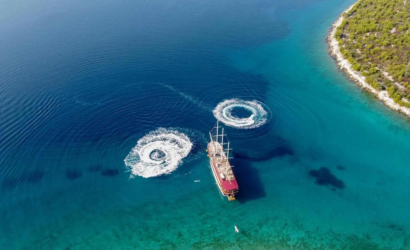 Amorena motor yacht seen from above, parked on clear water