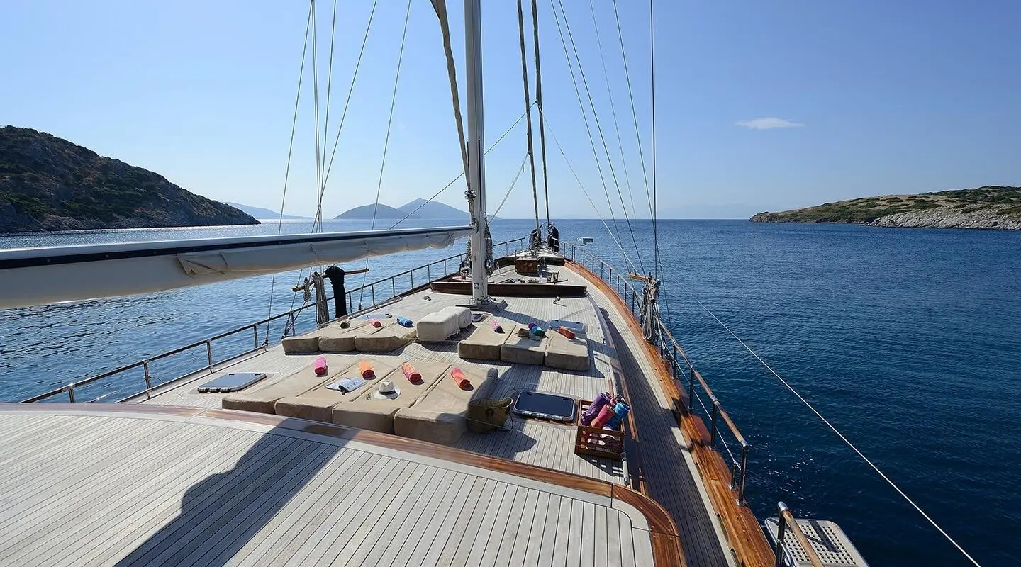 Zephyria II luxury gulet deck with wooden railings and calm sea at sunset
