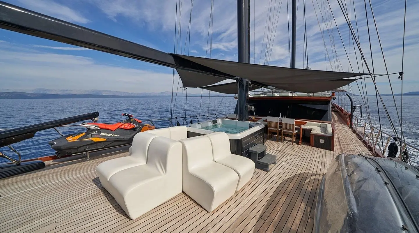 Stella Maris yacht deck with white seating, sunshade, and calm sea horizon