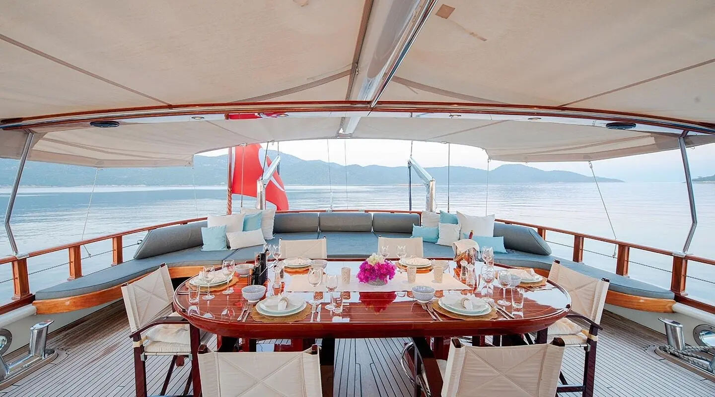 Cobra King yacht aft deck with table set for dining under a canopy