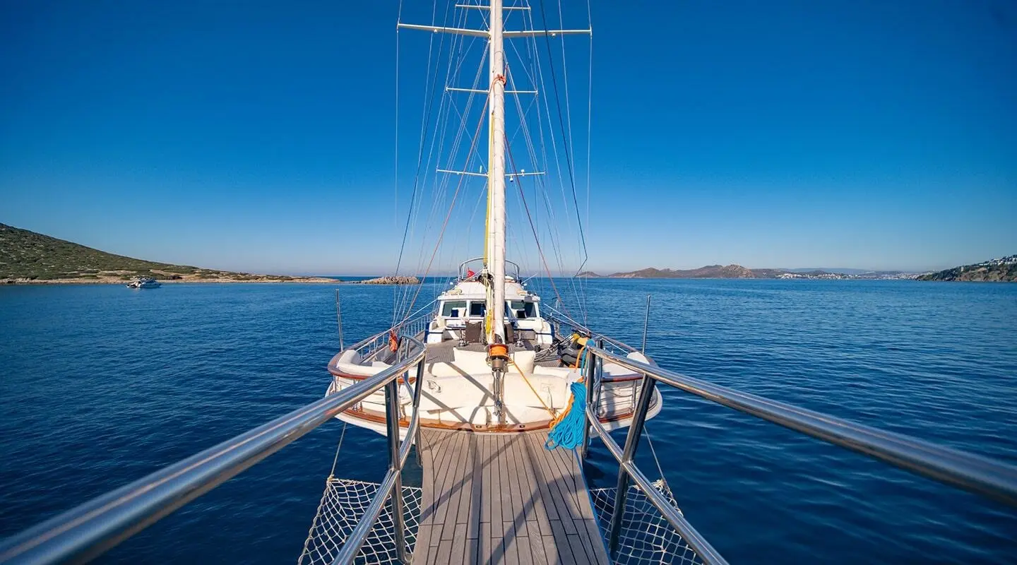 View from the bow of a luxury yacht at sea, rigging and deck ahead