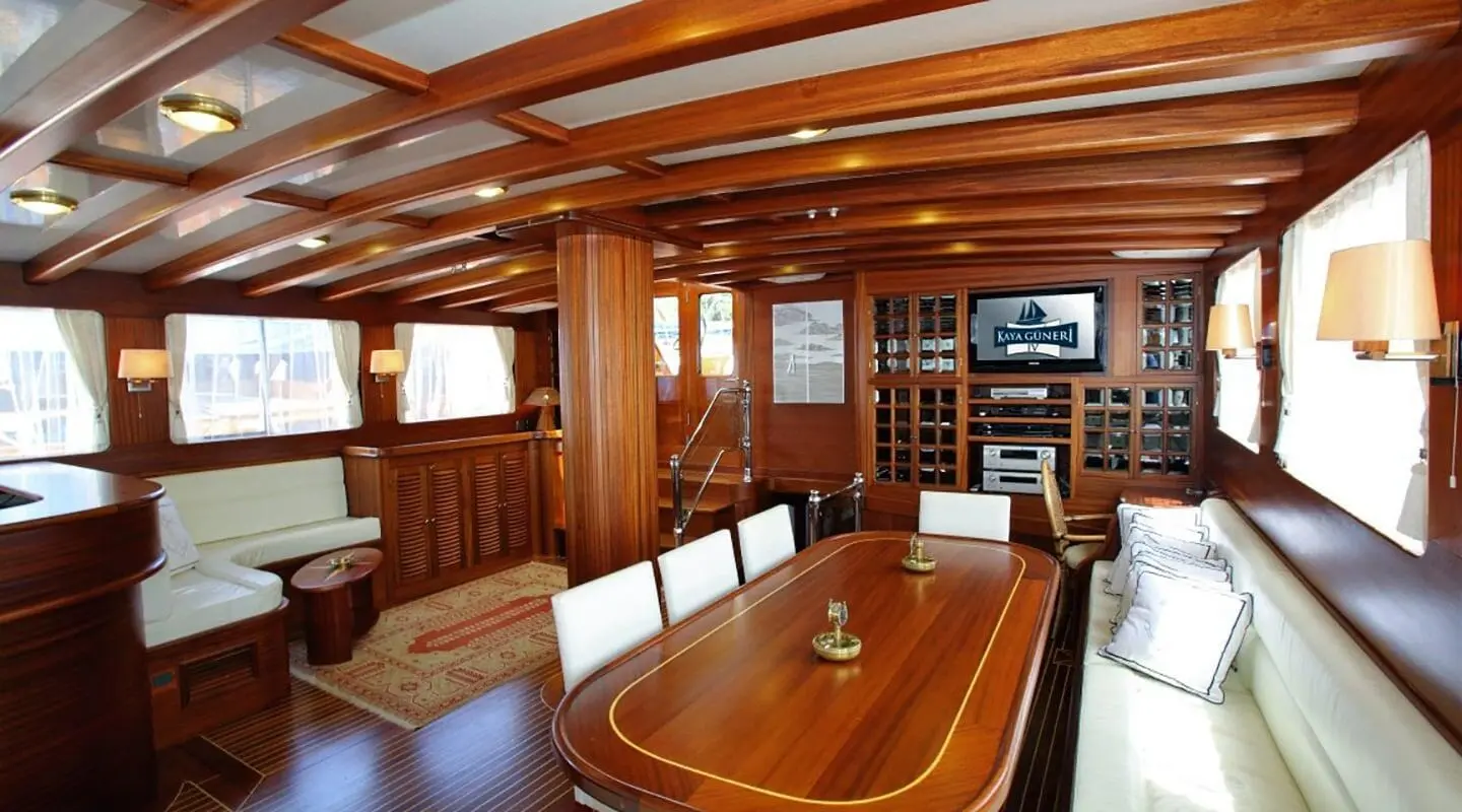 Luxurious yacht Kaya Guneri 4 interior with wooden dining table and seating