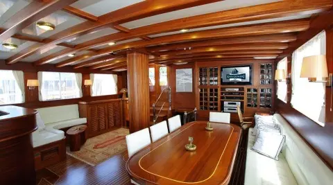 Luxurious yacht Kaya Guneri 4 interior with wooden dining table and seating