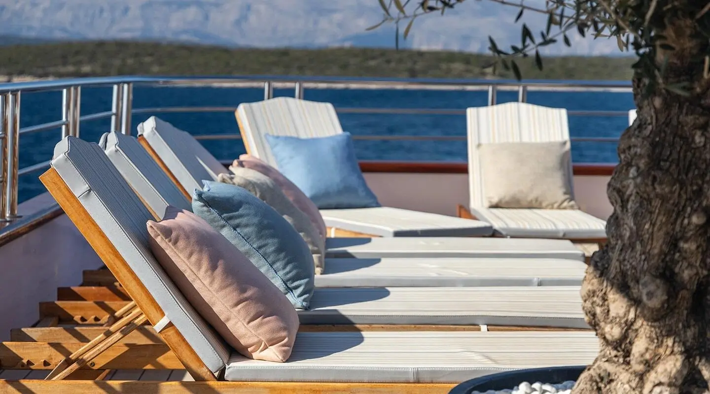 Olimp yacht on deck with sun loungers and cushions