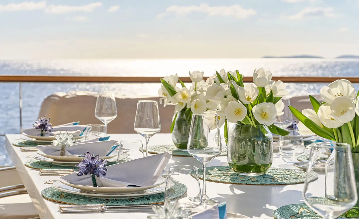 La Pellegrina 1 yacht dining setup at sunset with flowers and glassware