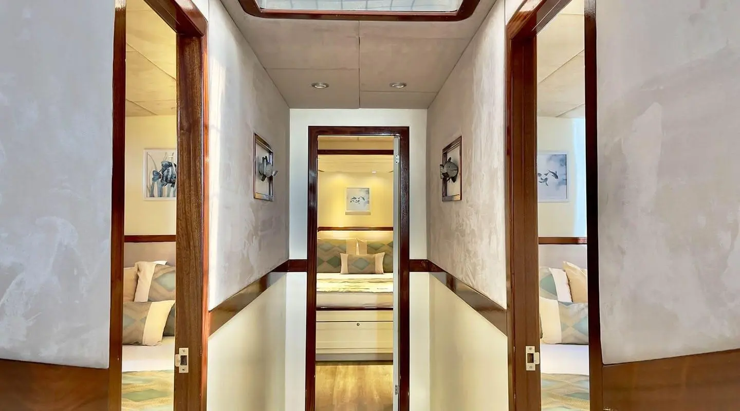 Interior corridor of Derya Deniz yacht with cabins and framed art