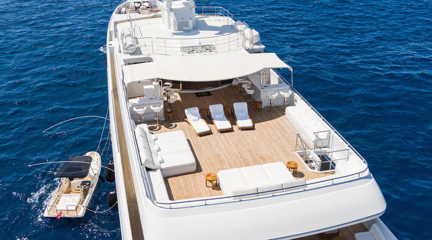 Top view of Apogee yacht sun deck with loungers and seating on teak deck