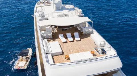 Top view of Apogee yacht sun deck with loungers and seating on teak deck