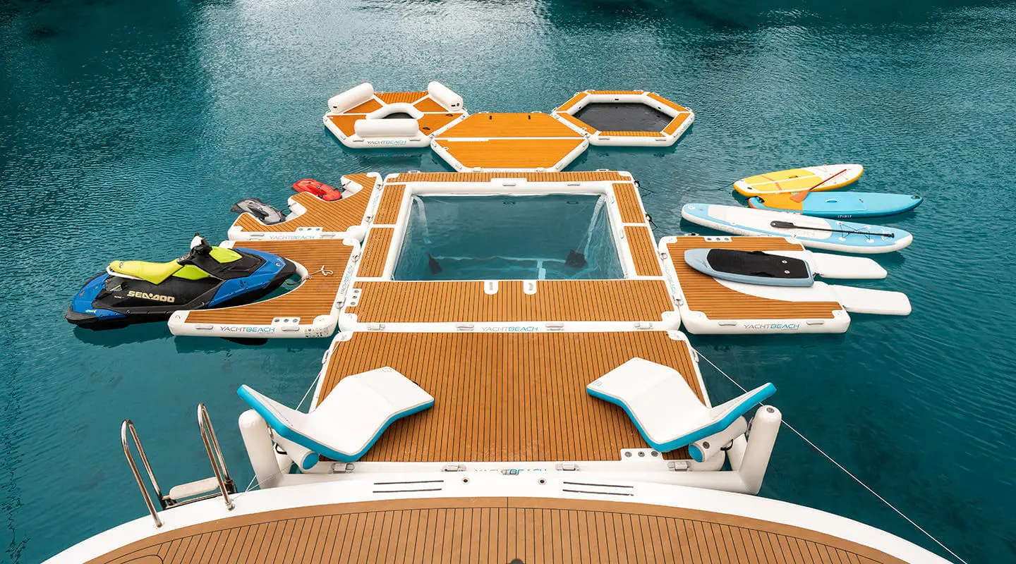 Top-down view of Cristal yacht with orange deck, surrounded by small boats
