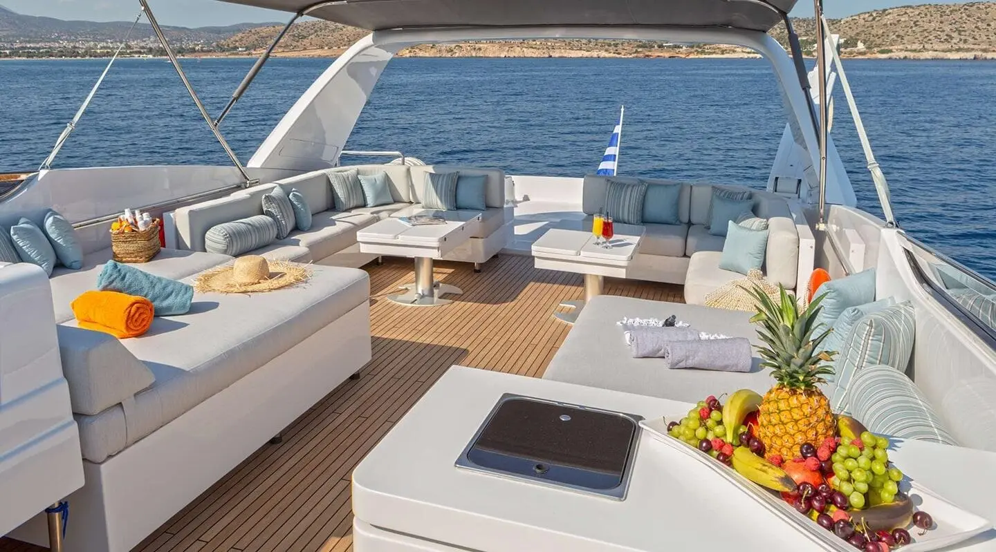 Grace luxury motor yacht deck at sunset with seating, white furniture, and calm sea