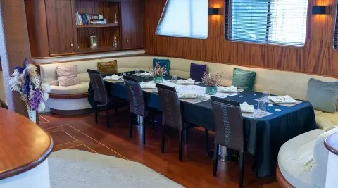 Nevra Queen luxury yacht interior: polished wood bar area with dark stools