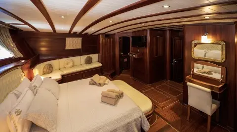 Arif Kaptan A yacht cabin interior with round bed and wooden paneling