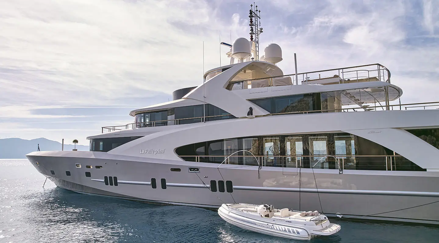 La Pellegrina 1 luxurious 50m yacht anchored with a tender on calm blue waters