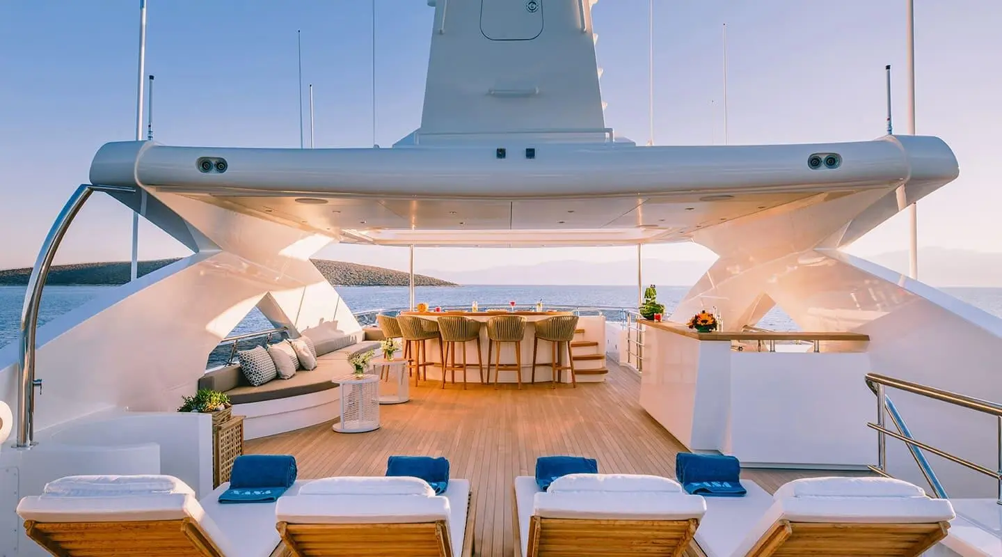 Xana luxury yacht deck with sun loungers and seating under open sky