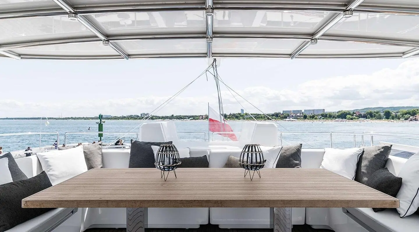 Dingy cabin dining area aboard Above & Beyond gulet, deck chairs and table visible