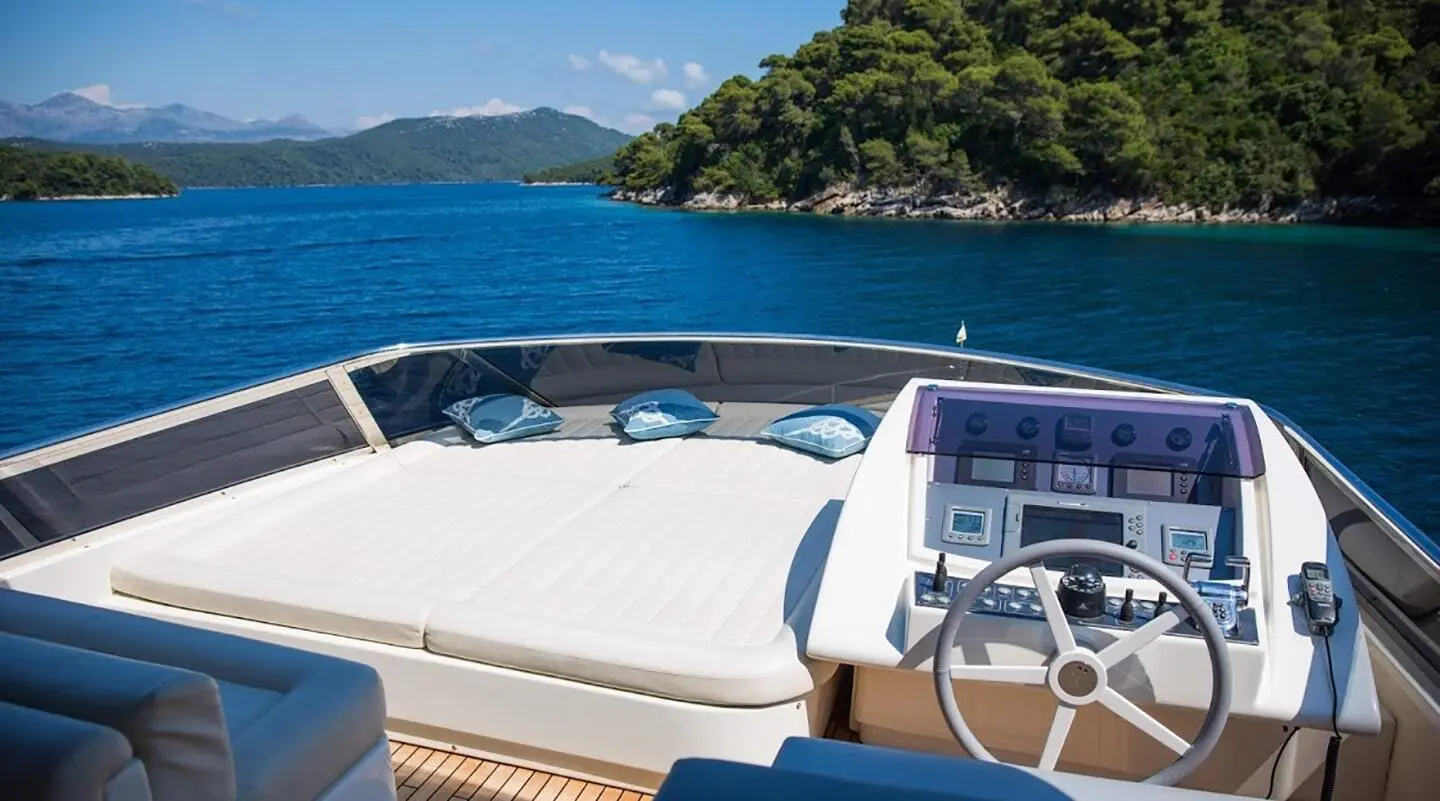 Salt yacht deck with seating, white railings, and blue water scene