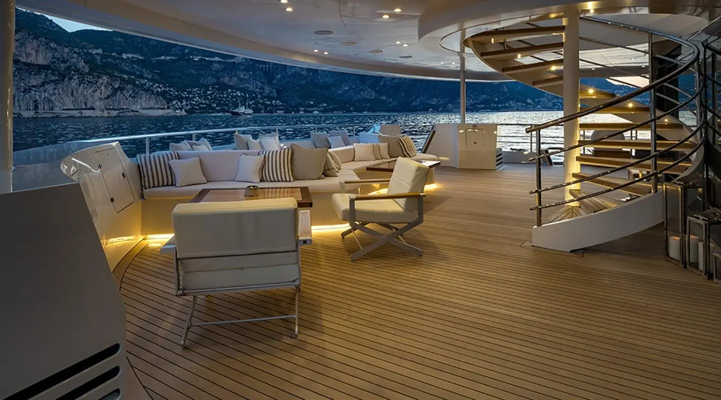 Marquise yacht lounge on deck with tan seating and blue sea backdrop