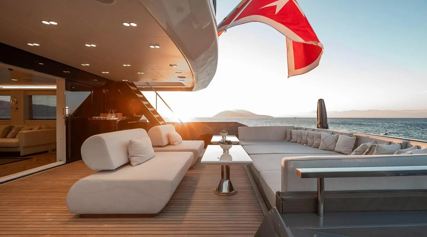 Illusion II aft deck with shaded seating, teak deck, and a red parasail in the distance