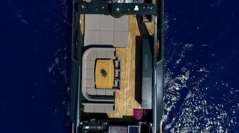 Overhead view of a luxury yacht named Can't Remember at sea, sunlit deck