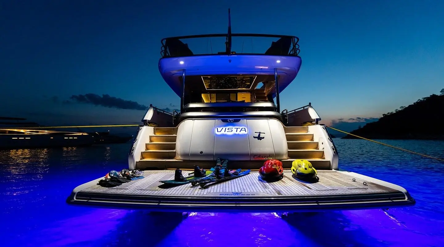 View of Vista luxury yacht at sea with illuminated stern and stairs at night