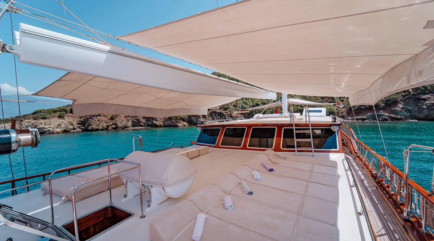Onyx Lycian Queen yacht deck at sunset, awning, seating, railing over turquoise sea