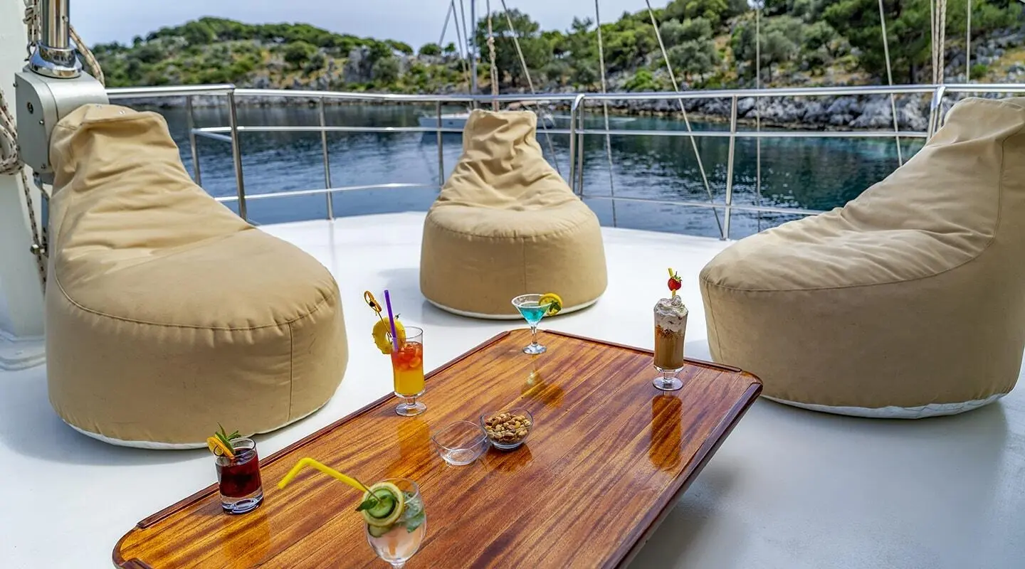 Gulet Tersane 8 yacht deck with wooden table, beverages, and seating on flybridge