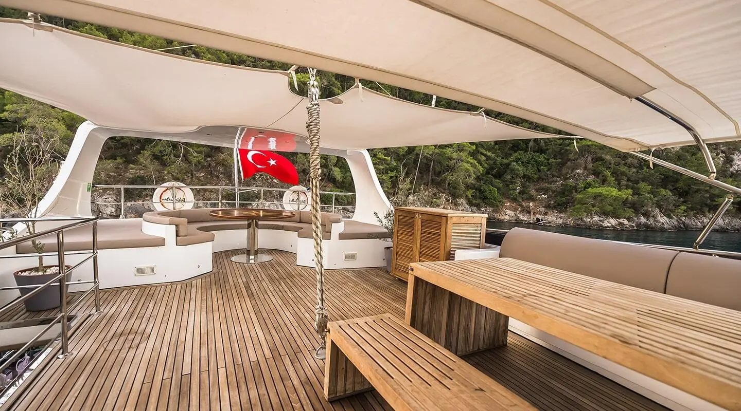 Belgin Sultan yacht deck at sunset with wooden stairs and seating area