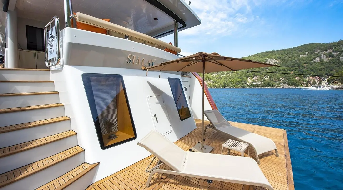 Simay M luxury motor yacht deck with sun loungers and blue water