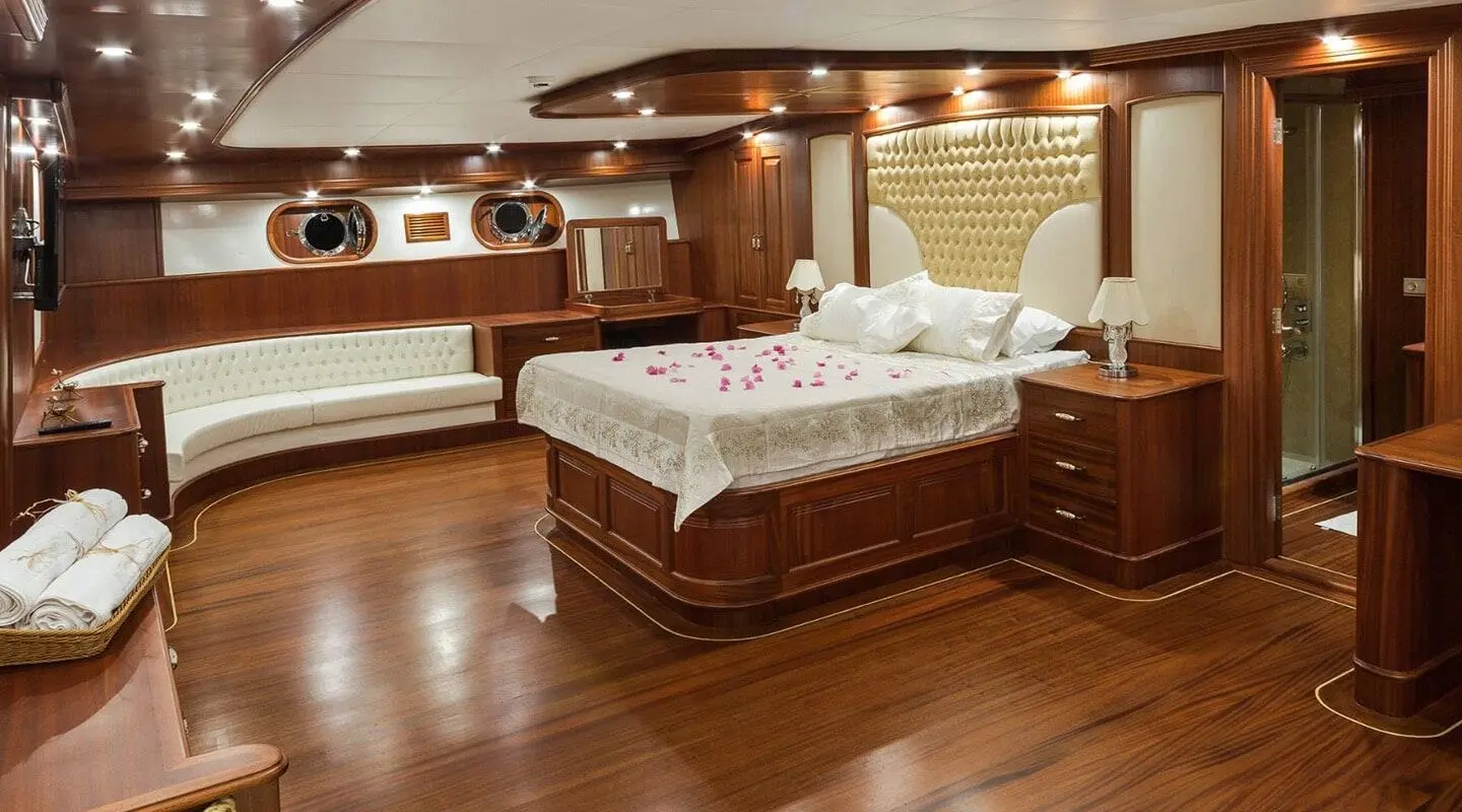 Halcon Del Mar luxury yacht interior with twin beds, wood paneling, and warm lighting