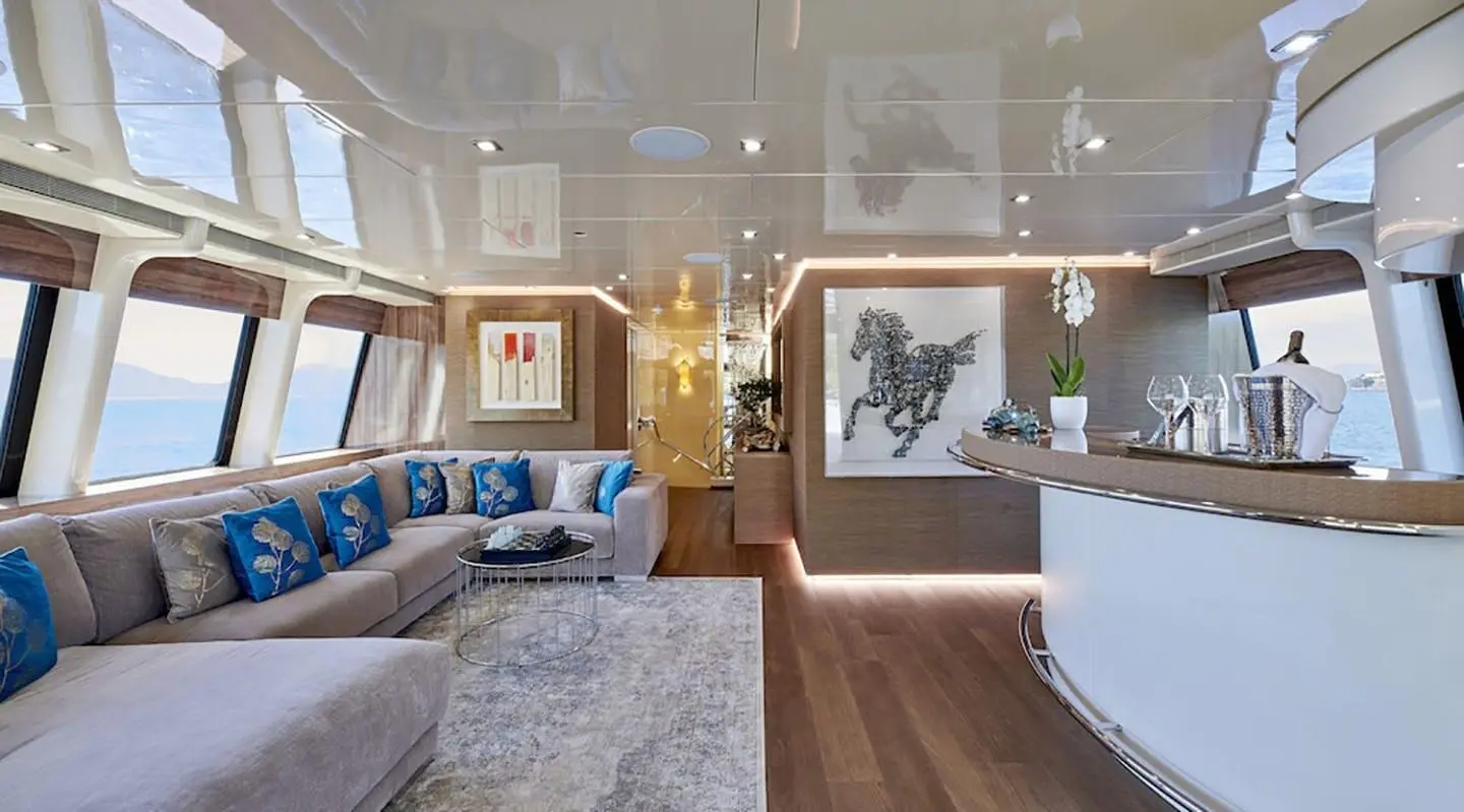 Daloli yacht lounge: polished wood floor, seating, and a TV on wall