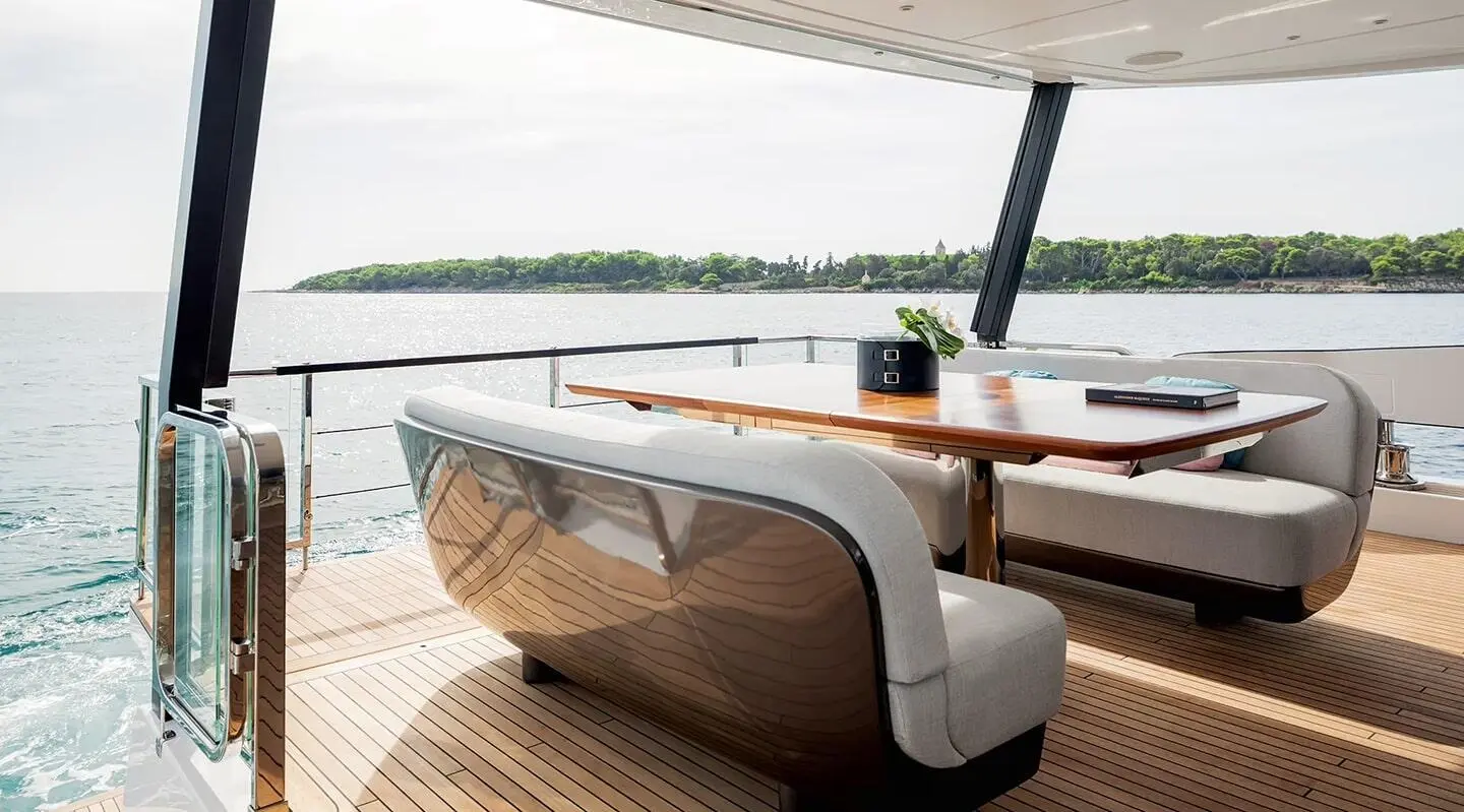 Viva II luxury yacht deck dining area with teak seating and umbrellas