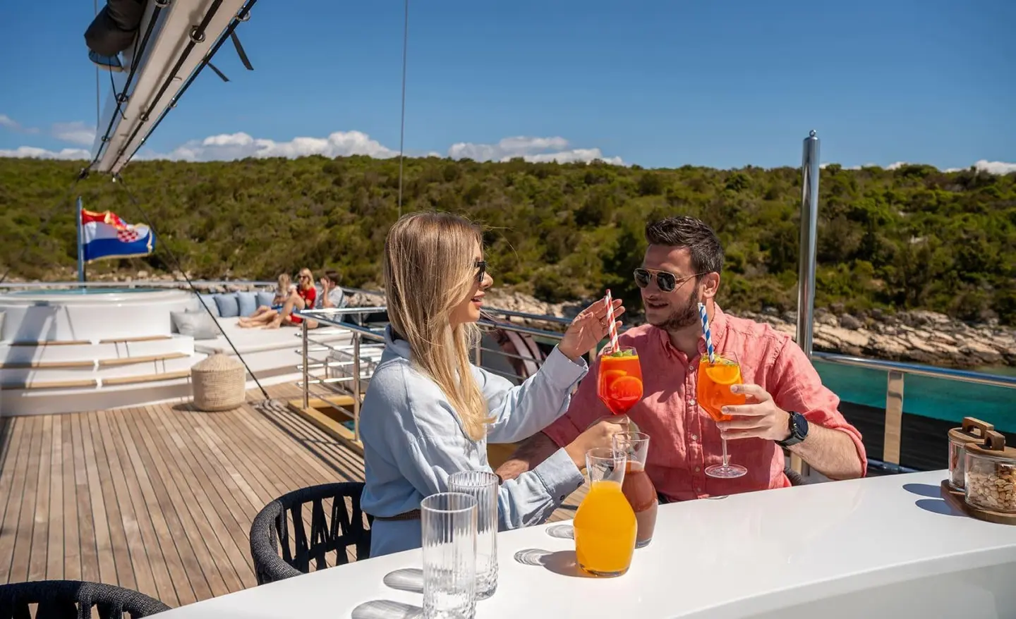 Anima Maris motor yacht sun deck with people chatting at a table