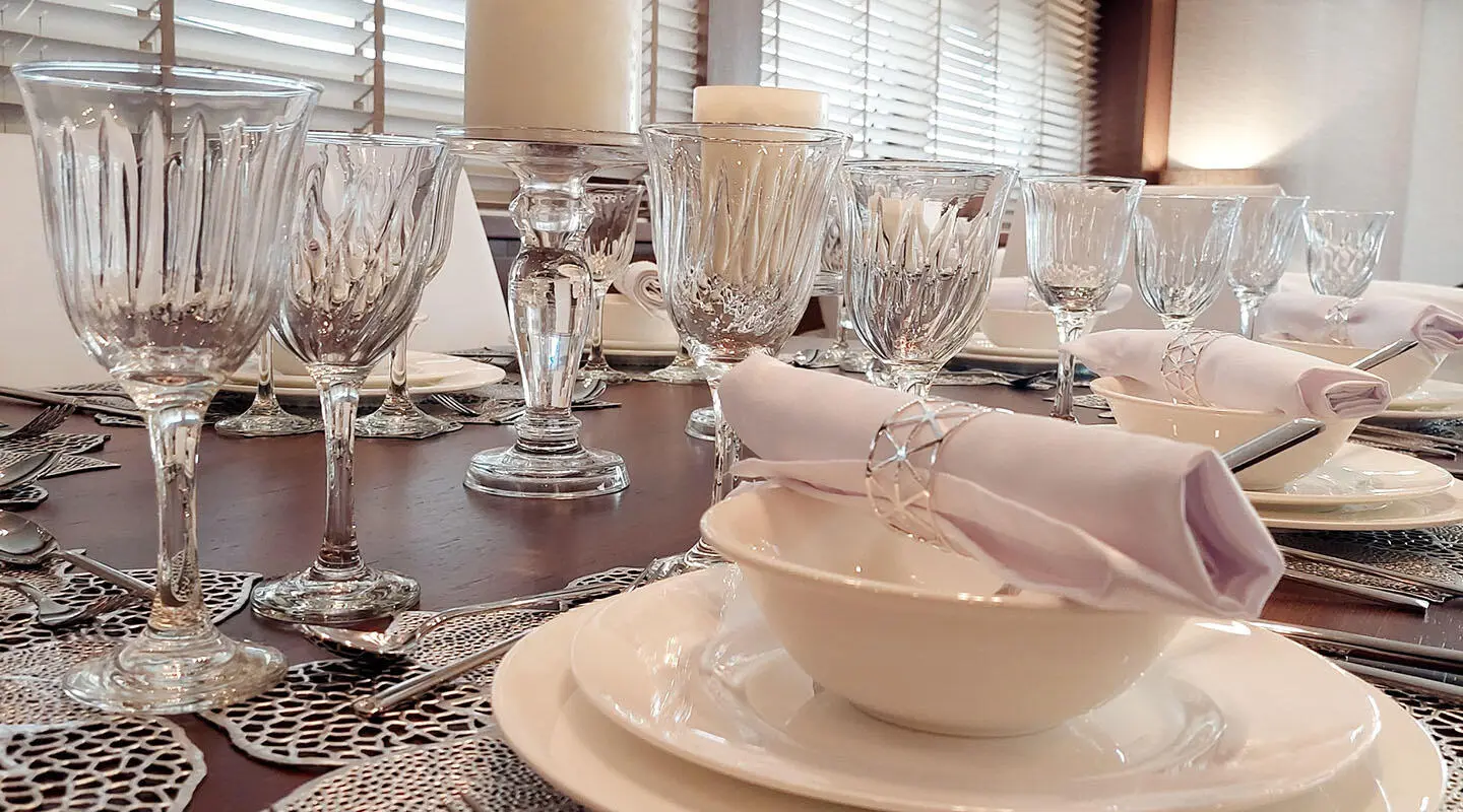 Table set for dining on Miraval yacht with plates, glasses, and napkins