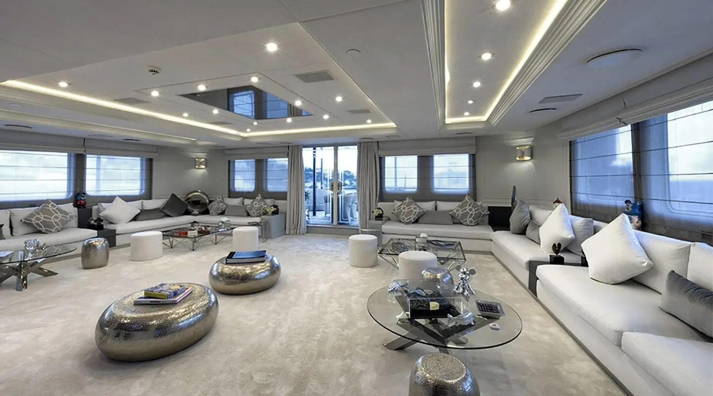 Chakra luxury yacht salon interior with seating, tables, skylights, and panoramic windows