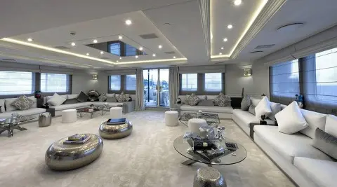 Chakra luxury yacht salon interior with seating, tables, skylights, and panoramic windows
